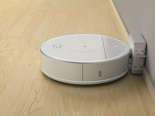 istock Robotic vacuum cleaner or sweeper at charging station 1409193748