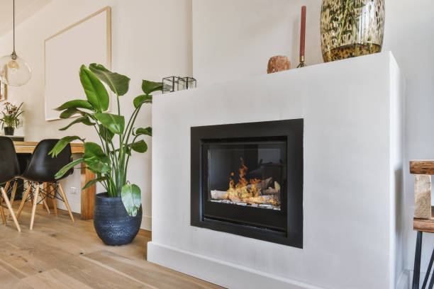 Modern fireplace in white wall Contemporary fireplace with glass screen installed in white wall in living room at home fireplace stock pictures, royalty-free photos & images