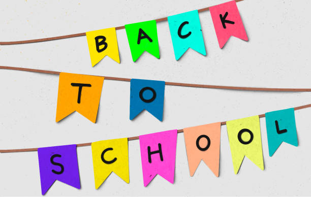istock Back to school on colorful small colorful flag hang on rope background. Back to school card or banner with typography design. 1409203611