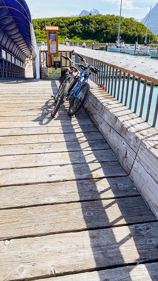 A two bikes stand at the ready. Sitting at the pier, these bikes are ready for adventure or to help get around at the docks.