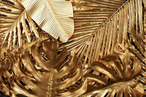 istock Creative nature gold layout made of tropical leaves. 1409213570