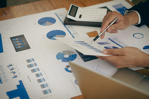 Business advisor meeting to analyze and discuss the situation of financial reports in the financial advisor meeting room, financial advisory and success concept of financial strategy statistics.