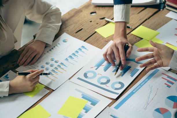 istock team work process Businessman working in the office discussing paperwork and working on financial reports. Talk about an investment business plan. financial analysis concept 1409217358