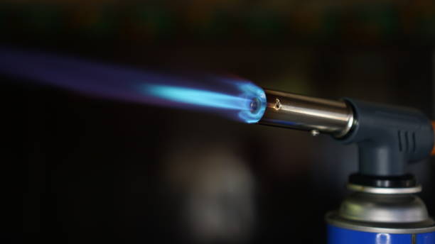 istock Fire flame of portable gas torch with dark background 1409218262