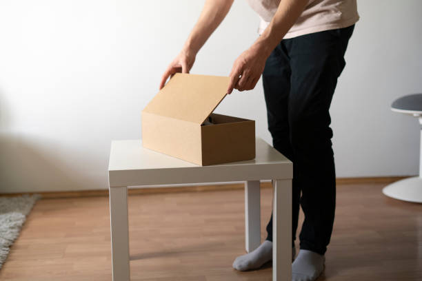 istock opening the cardboard box with new order purchase 1409218510