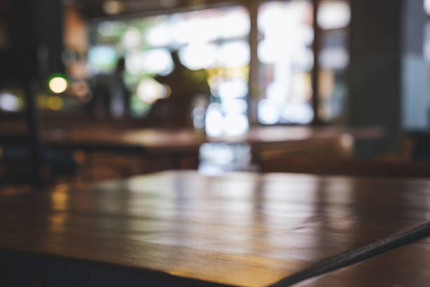 istock Wooden table top with blurred background in cafe 1409218556