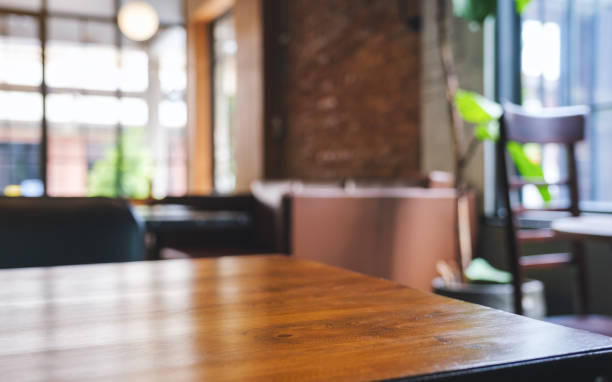 istock Wooden table top with blurred background in cafe 1409218561