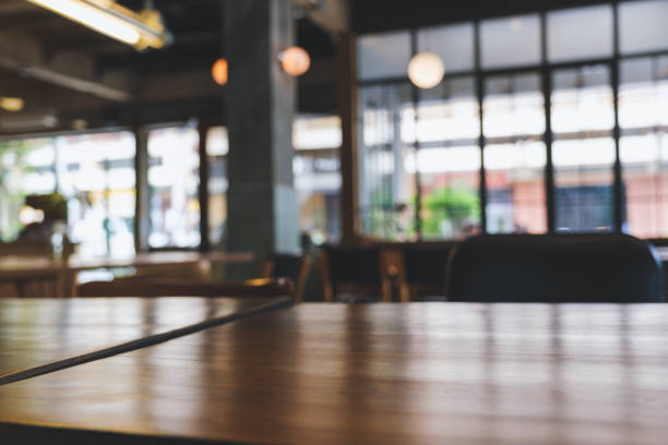 Wooden table top with blurred background in cafe
