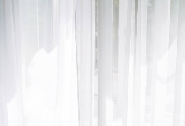 istock White tulle curtains on the window background texture 1409218706