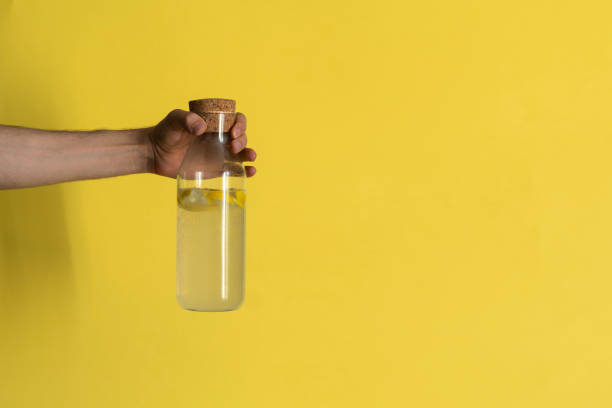 istock person holding a bottle with summer lemon mojito cocktail 1409219823