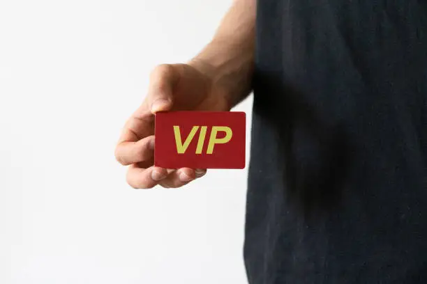 Photo of person showing VIP card pass, exclusive access membership