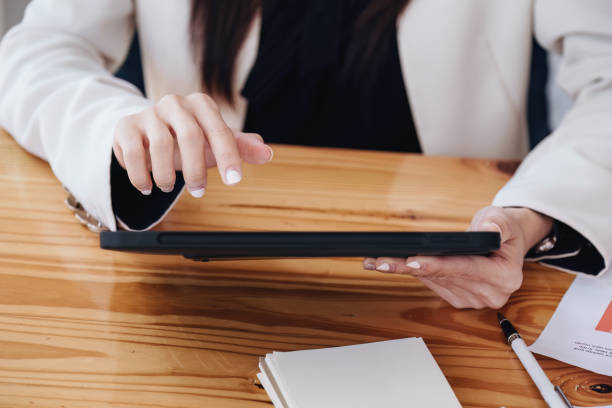 istock business woman using a tablet computer for data analysis, marketing, accounting 1409225827
