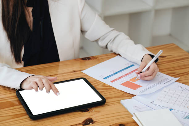 istock business woman using a tablet computer for data analysis, marketing, accounting 1409225882