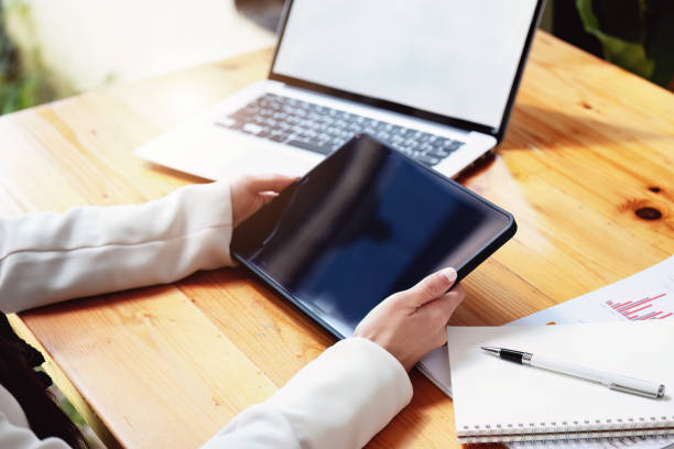 istock business woman using a tablet computer for data analysis, marketing, accounting 1409226656