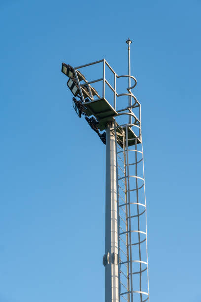 istock Big and tall stadium spot light against blue sky 1409230335