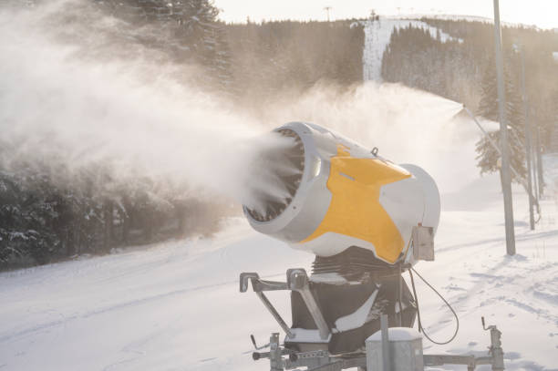 istock Snow cannon in winter mountains. Snow-gun spraying artificial ice crystals. Machine making snow. 1409233432