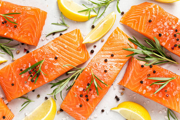 istock Salmon. Fresh raw salmon fish fillet on white background 1409236221