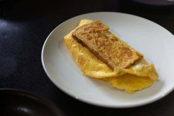 istock Sandwiches with egg, ham and toast cheese fried in white dish 1409238665