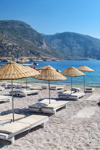 Beach umbrellas and sun loungers on Oludeniz Beach in Turkey stock photo