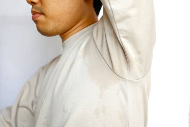 This man's clothes are soaked by underarm sweat. This man's clothes are soaked by underarm sweat. sweat gland stock pictures, royalty-free photos & images