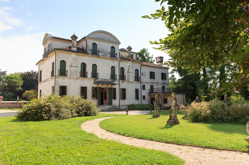 Mira, Italy - August 13, 2020: Garden with statues at Villa Widmann in Riviera del Brenta. The present palace was built in the 18th century and is also called Widmann-Rezzonico-Foscari.