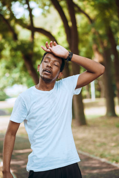 istock Young man working out at public park on hot sunny morning 1409247400