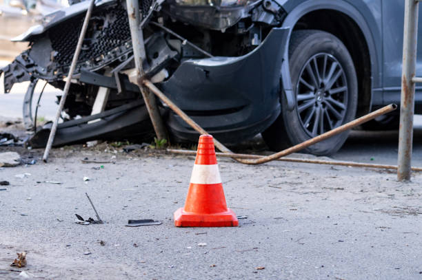 road cone against the background of a car broken in a road accident road cone against the background of a car broken in a road accident. Selective focus road accident stock pictures, royalty-free photos & images