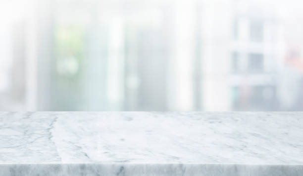 istock Selective focus.Marble table top on blur abstract window glass background. 1409254717