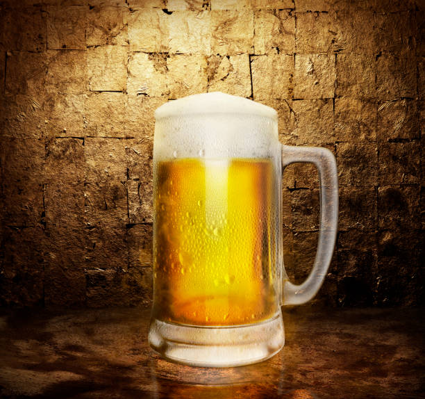 istock beer glass on dark golden color background. 3d render 1409256081