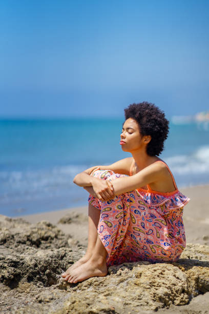 istock Calm black woman resting against sea 1409260929