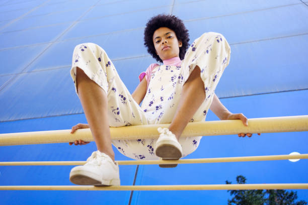 istock Black woman sitting on railing in city 1409260944