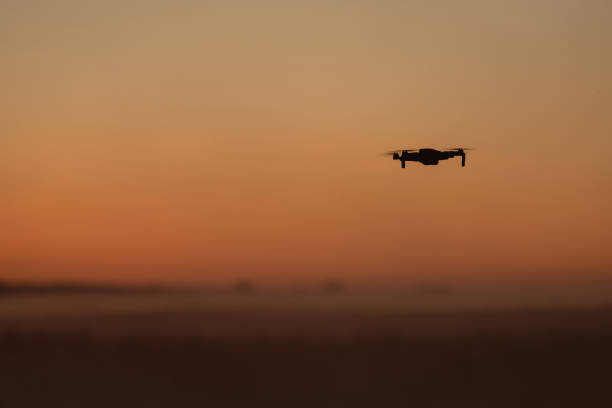 istock A quadcopter is flying in the sunset sky 1409262111