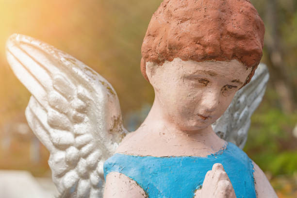 istock Angel child in prayer. (concept: child loss, death of a child) 1409265642
