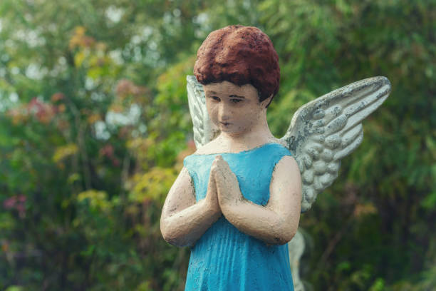 istock Angel child in prayer. (concept: child loss, death of a child) 1409265648