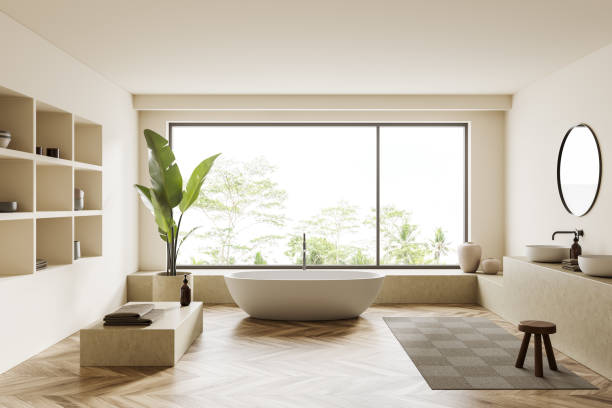 istock Light bathroom interior with bathtub, shelf with decoration and sink, window 1409268432