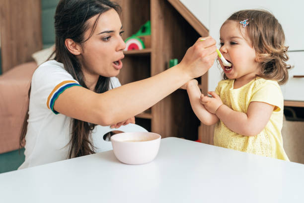 istock Mother feeding her girl 1409268533