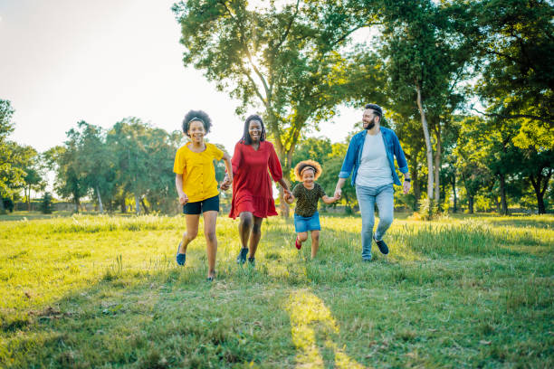 istock Family walking through the park 1409268865