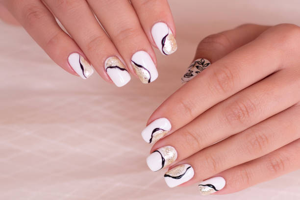 istock Female hands with golden manicure nails 1409268957