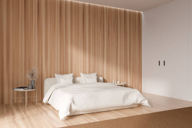 istock White bedroom interior with bed and decoration on nightstand. Empty wall 1409269693