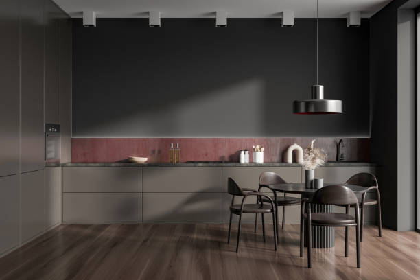 istock Dark kitchen interior with eating table and seats, shelves and kitchenware 1409269724