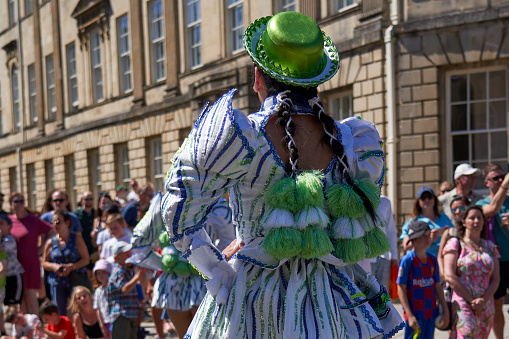 Bath, England, United Kingdom - 9 July 2022: Caporales dancers in ornate costumes performing at the annual carnival as it progresses through the streets of the historic city of Bath in Somerset.