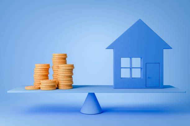 istock Money and house on scale, blue background. 1409270284
