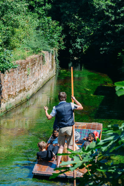 Tourists enjoy a punt ride on the River Stour in Canterbury, UK Canterbury, UK - July 15, 2022: Tourists enjoy a punt ride on the River Stour in Canterbury, UK canterbury england stock pictures, royalty-free photos & images