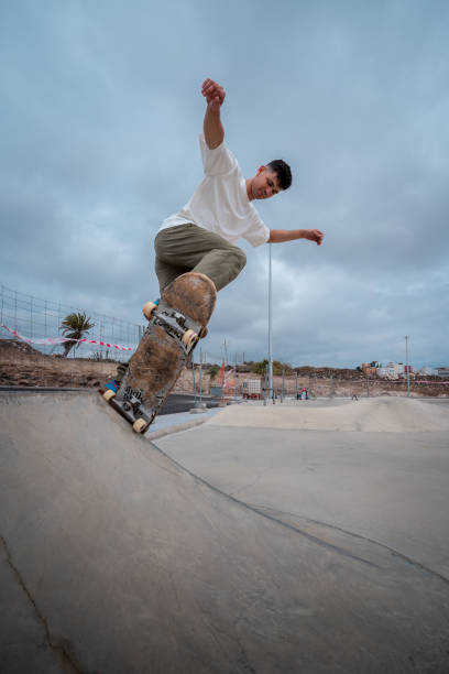 istock young skateboarder jumps over a ramp in a skate park. vertical composition 1409277301