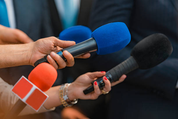 Microphones from news reporters, interview with a politician. stock photo