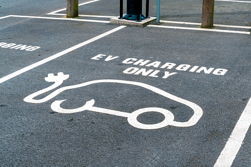 Car charging symbol painted on a parking space
