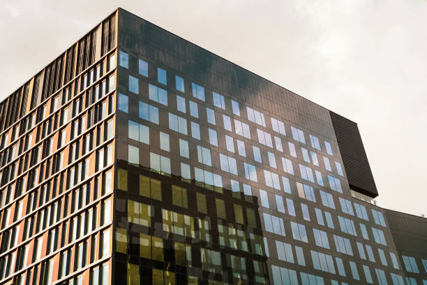 istock High corporate modern urban architecture building with glass windows and reflection of another building 1409279786