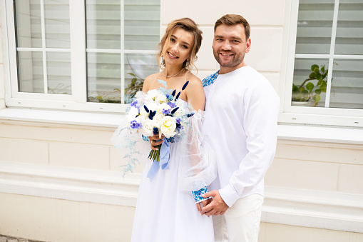 Young beautiful couple smiling happy and confident getting married.