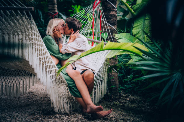istock Couple enjoy their love while lying down in a hammock 1409282880