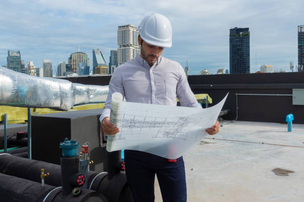 Engineer under checking the industry chilled water fan coil unit air conditioner is water cooling tower air chiller HVAC system of large industrial building to control air system